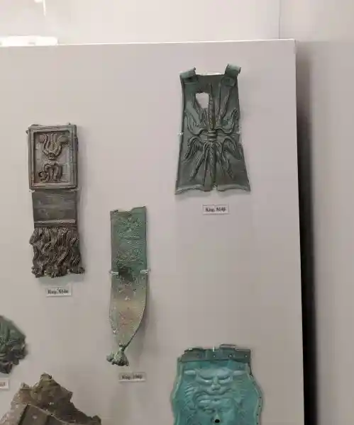Bronze armor pieces from statues featuring religious and celestial symbols